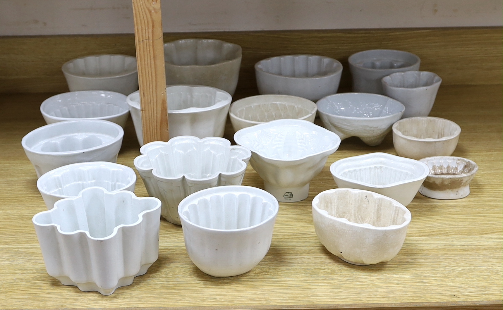 Eighteen white ceramic jelly moulds, examples, by Booth, Adams, Shelley, Greens, etc. tallest 14cm